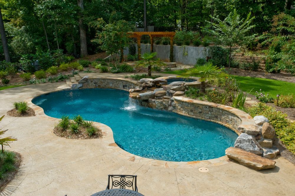 Inground swimming pool and spa with concrete deck