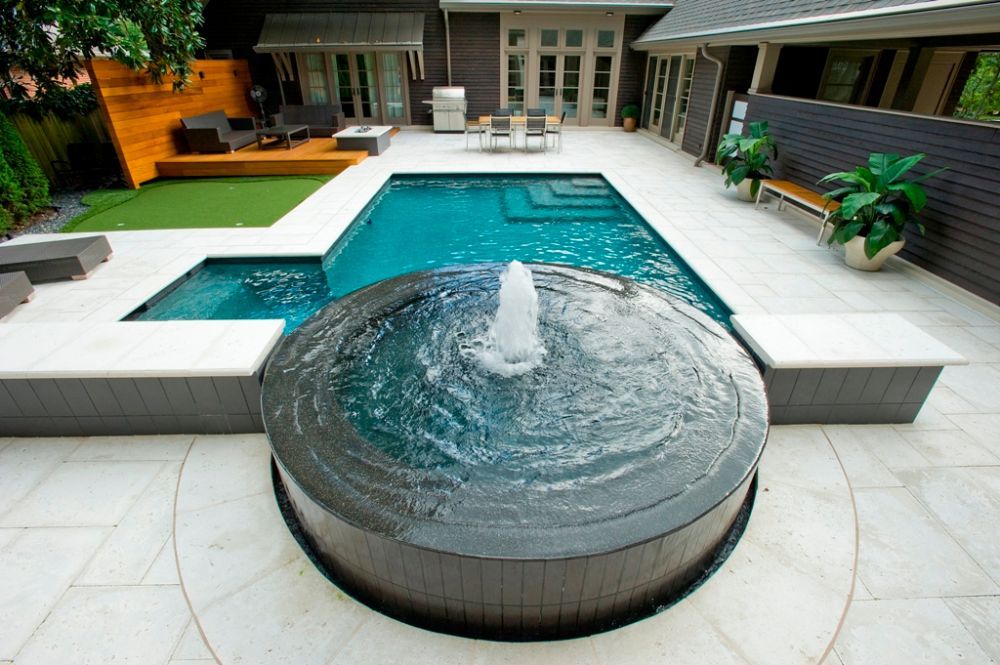 Inground swimming pool and spa with fountain