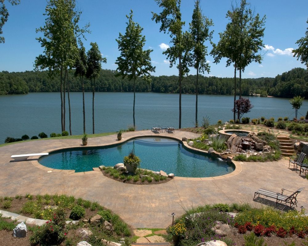 Inground swimming pool and spa with lake view