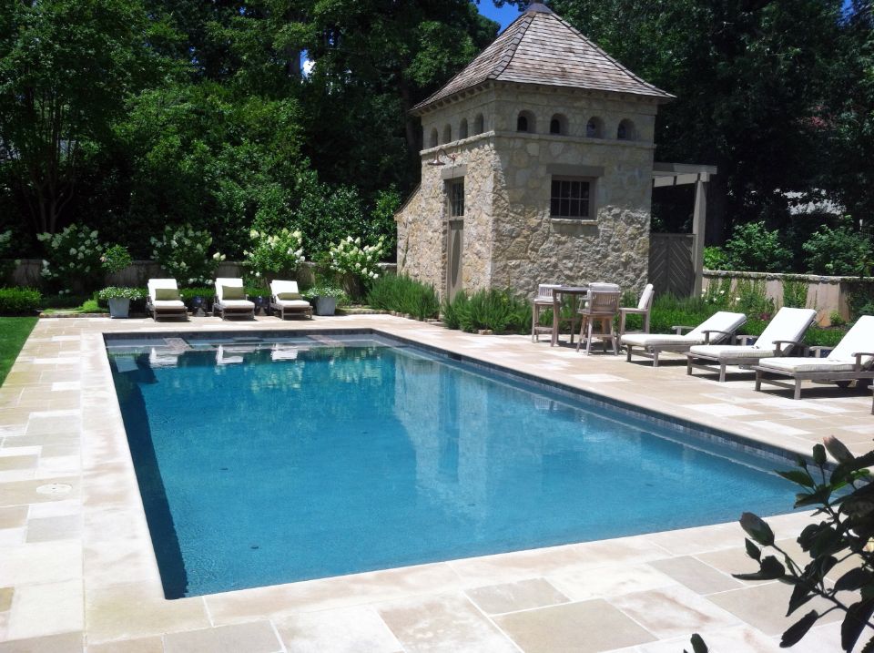 Inground swimming pool with flush spa and limestone deck