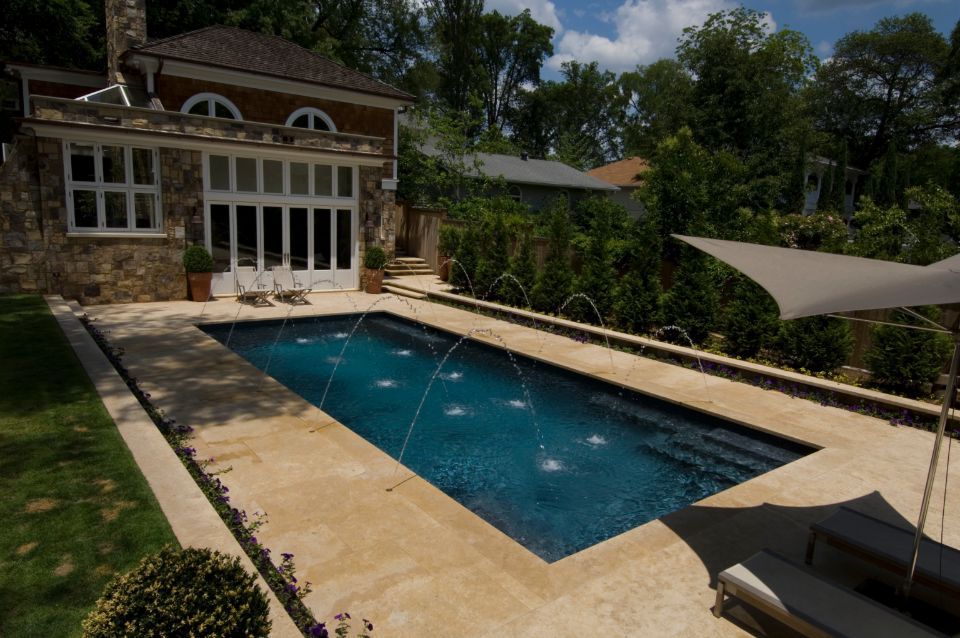Inground swimming pool with limestone and deck jets