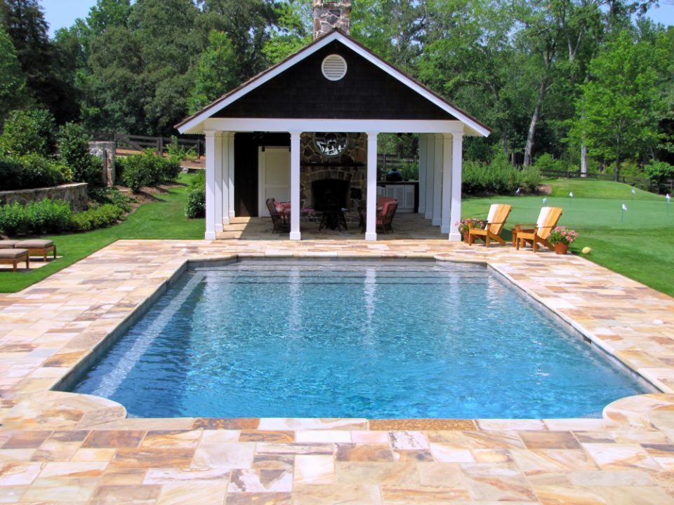 Inground swimming pool with flush spa and limestone deck