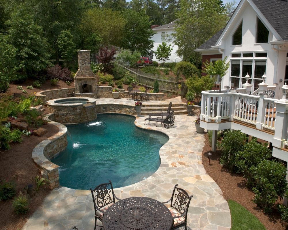 Inground swimming pool with raised spa irregular flagstone decking
