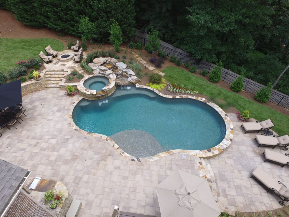 Inground swimming pool with spa and paver deck