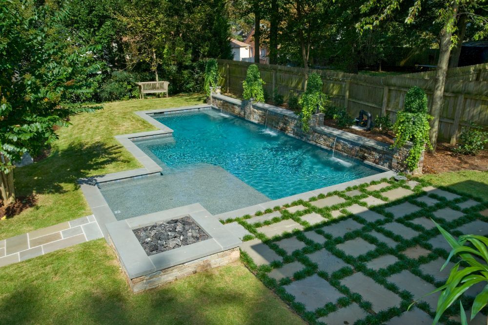 Inground swimming pool with sunshelf and firepit