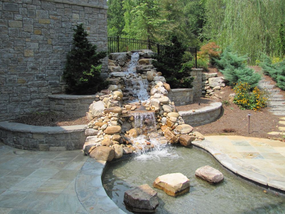 Outdoor waterfall with stepping stones