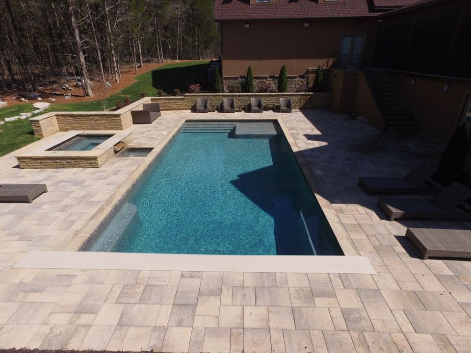 Pool with spa and rustic slab deck