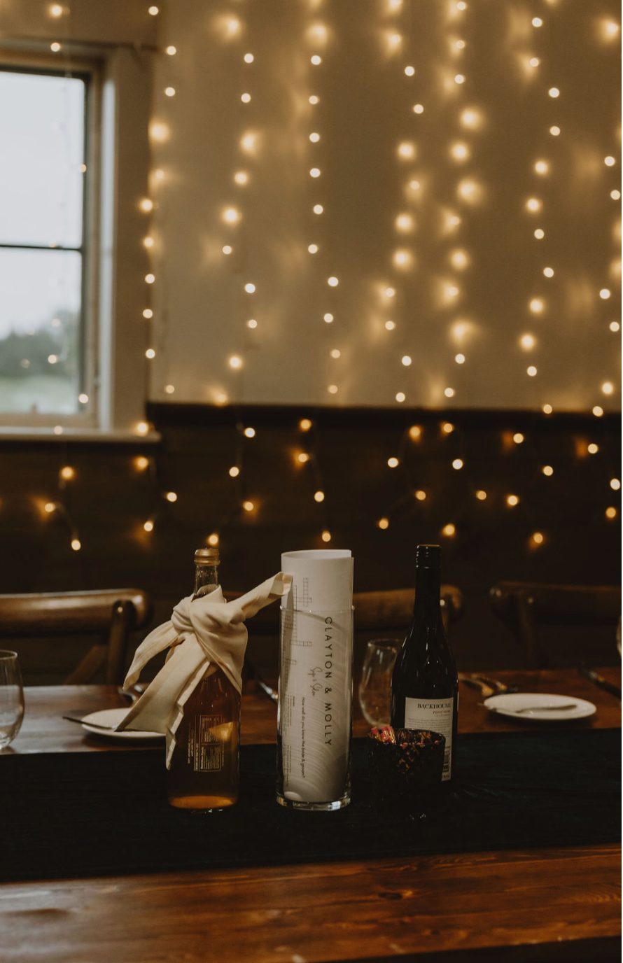 A table with a bottle of wine and a napkin on it.