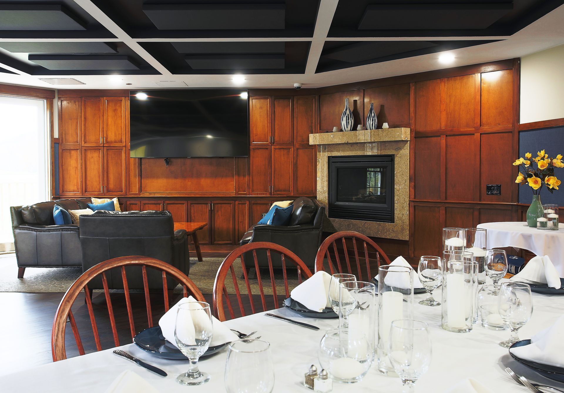 A dining room with a table and chairs and a fireplace