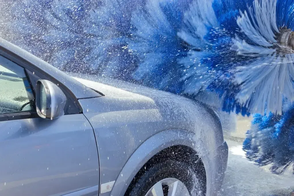 A car is being washed in a car wash.