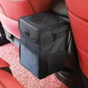 A trash can is sitting in the back seat of a car.