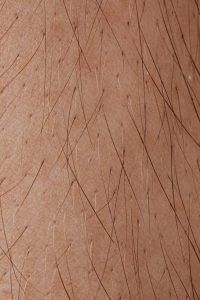 A close up of a person 's hair on their skin.