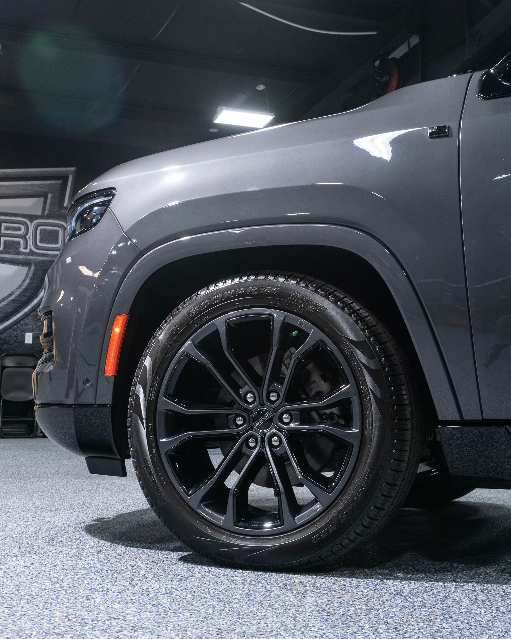 A man is spraying a tire with a spray bottle.