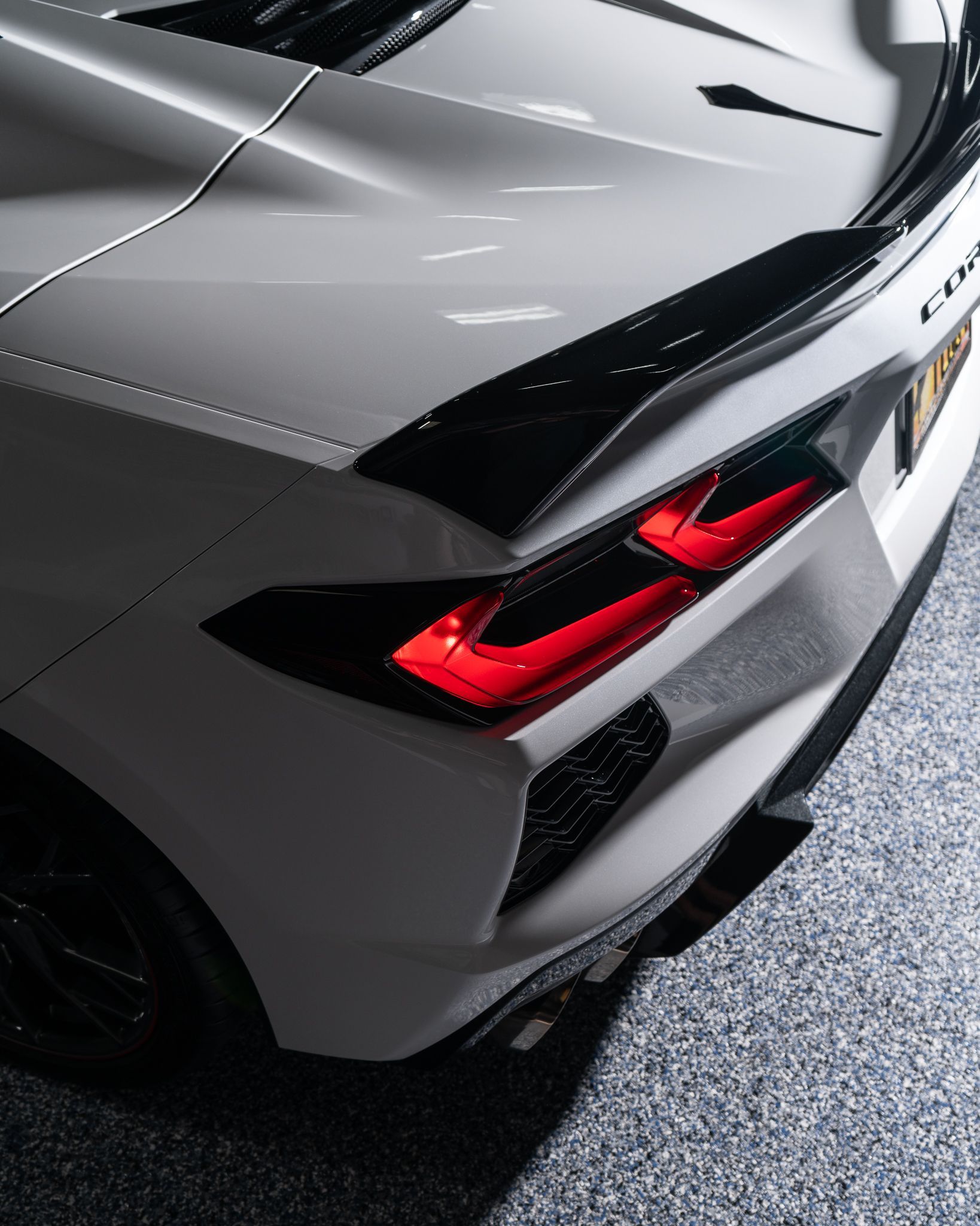 A close up of the back of a white corvette