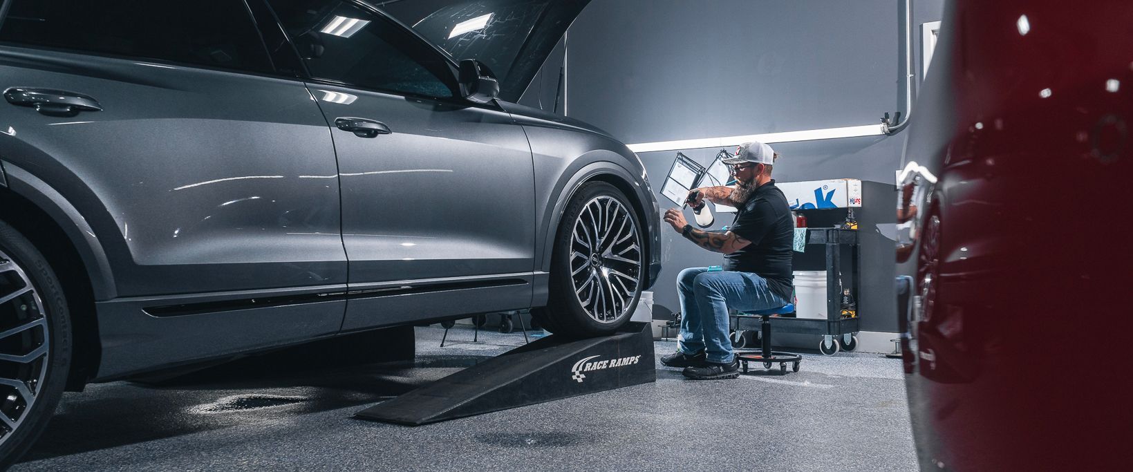 A man is working on a car in a garage.
