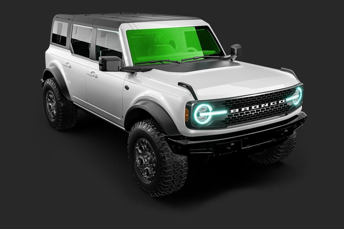 A white ford bronco with a green windshield on a black background.