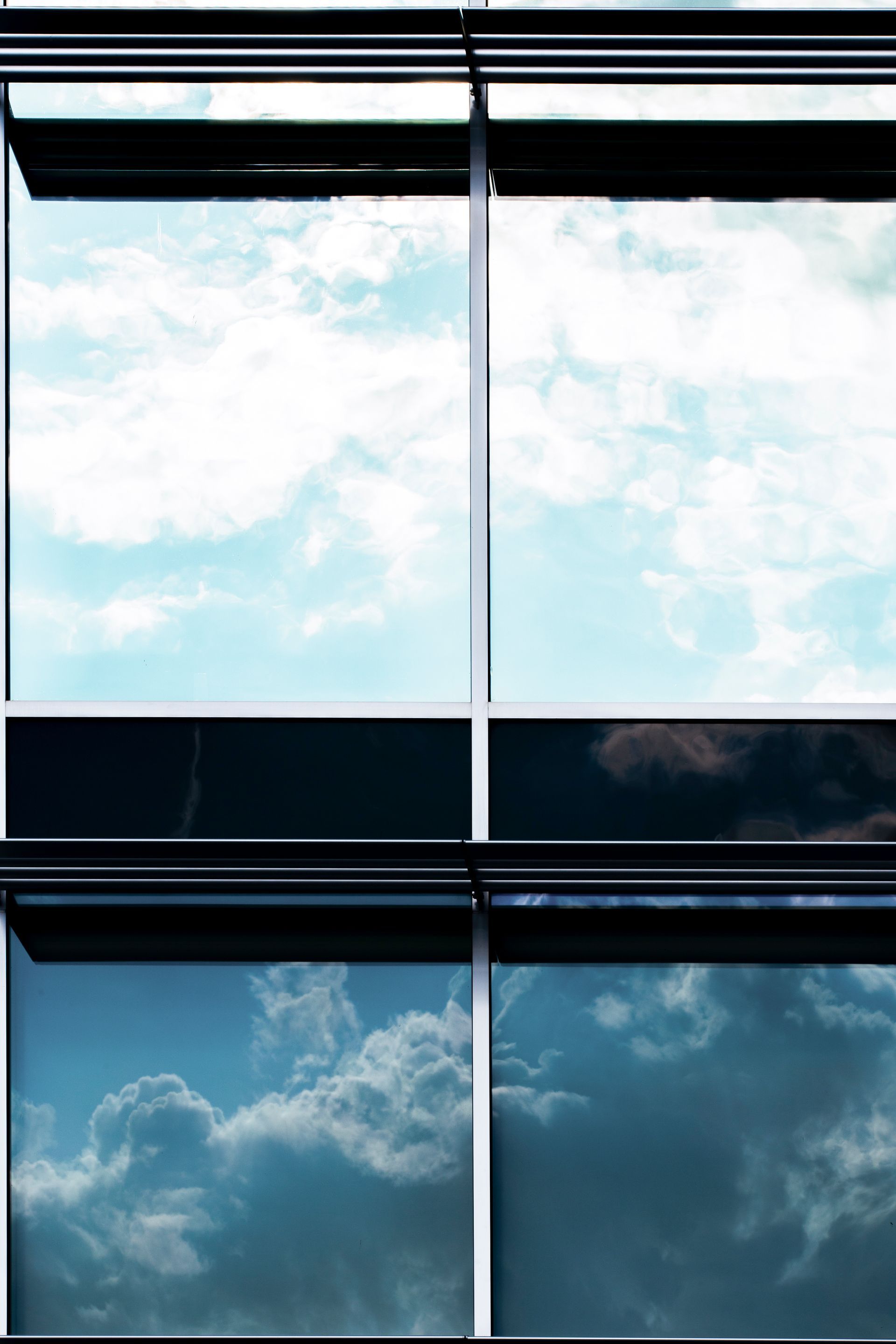 The sky is reflected in the windows of a building