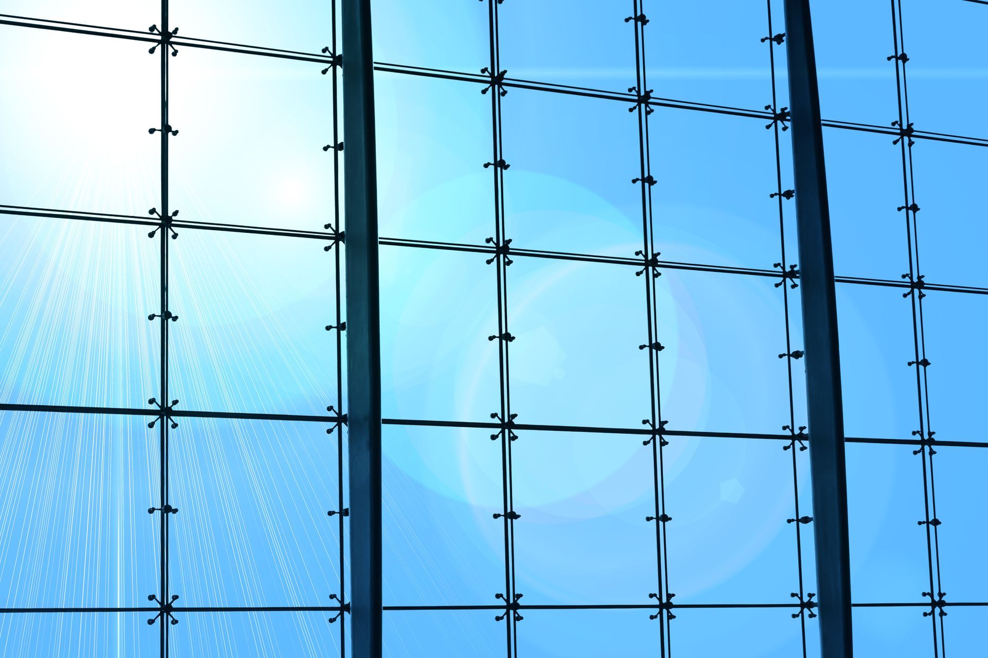 A barbed wire fence with a blue sky in the background