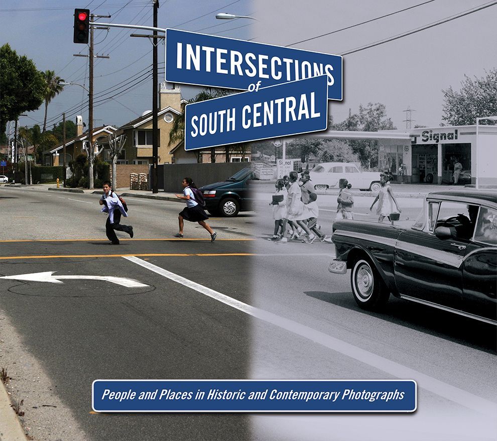 Photo of intersection; modern vs. historical views.  People crossing street in color, classic car and pedestrians in grayscale.