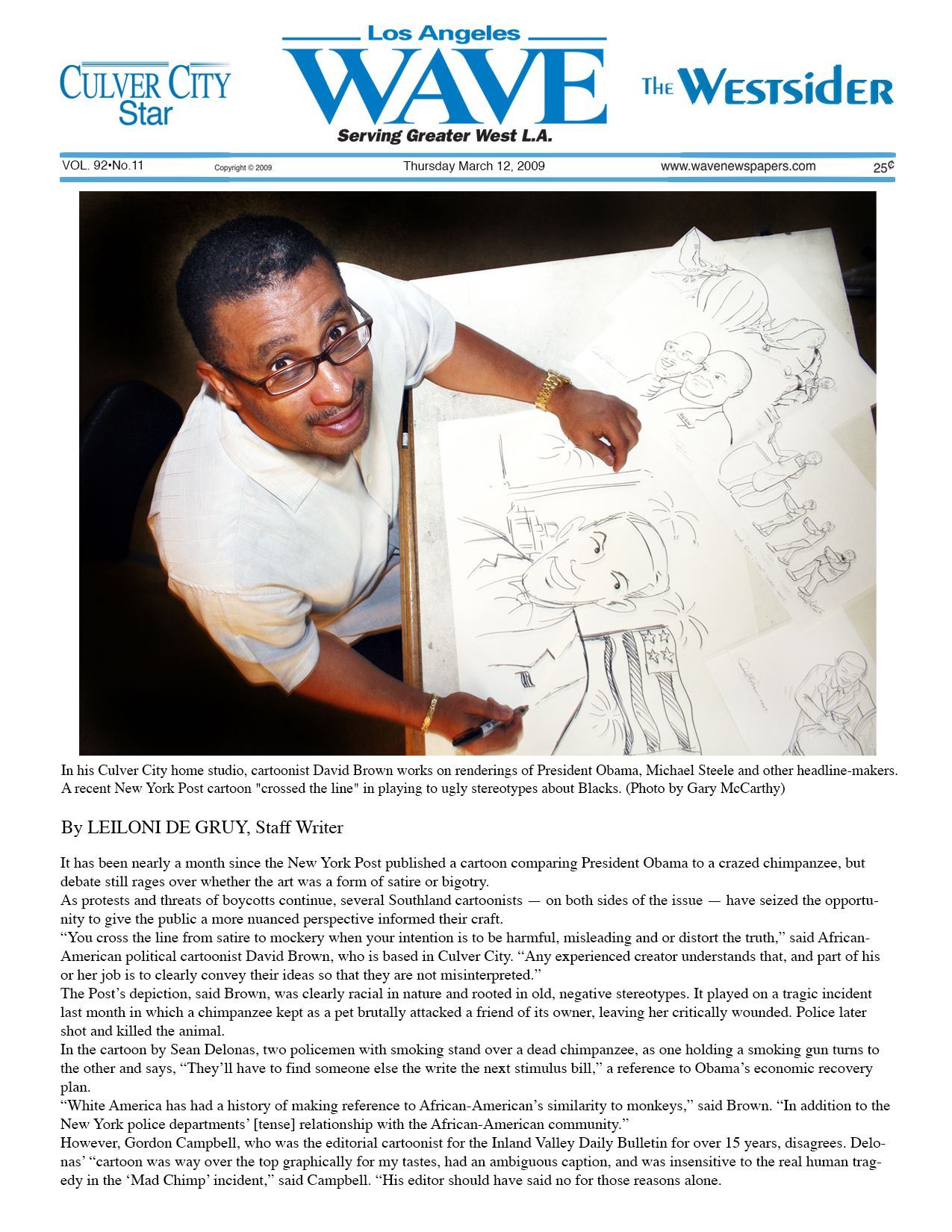 Man drawing on large paper, newspaper headline 