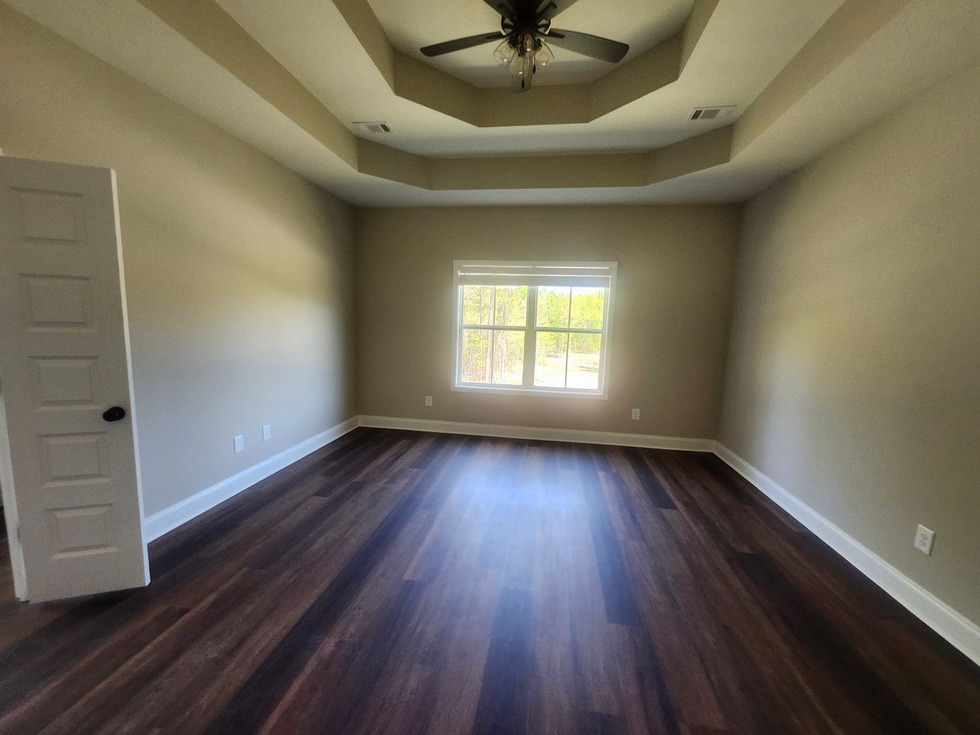 A person is working on a wooden desk with a screwdriver.
