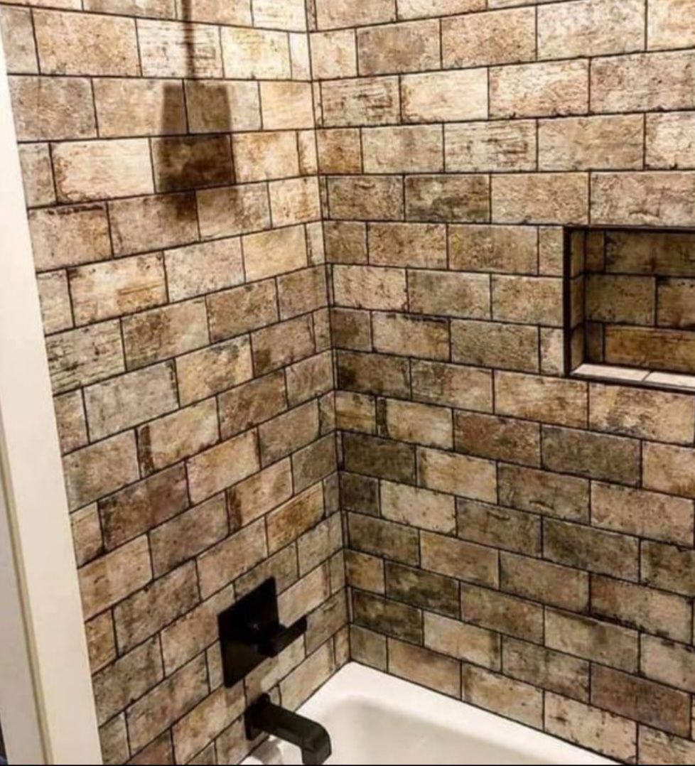 A person is putting something on a wooden shelf.