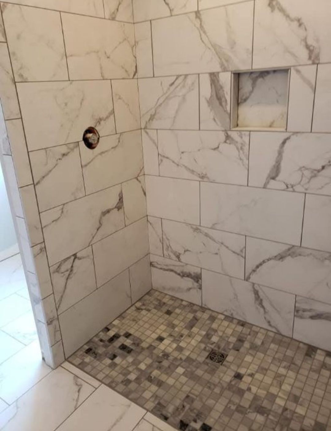 A person is putting something on a wooden shelf.