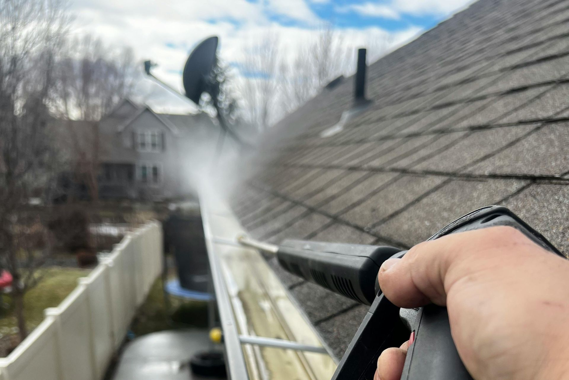 A person is working on a wooden desk with a screwdriver.