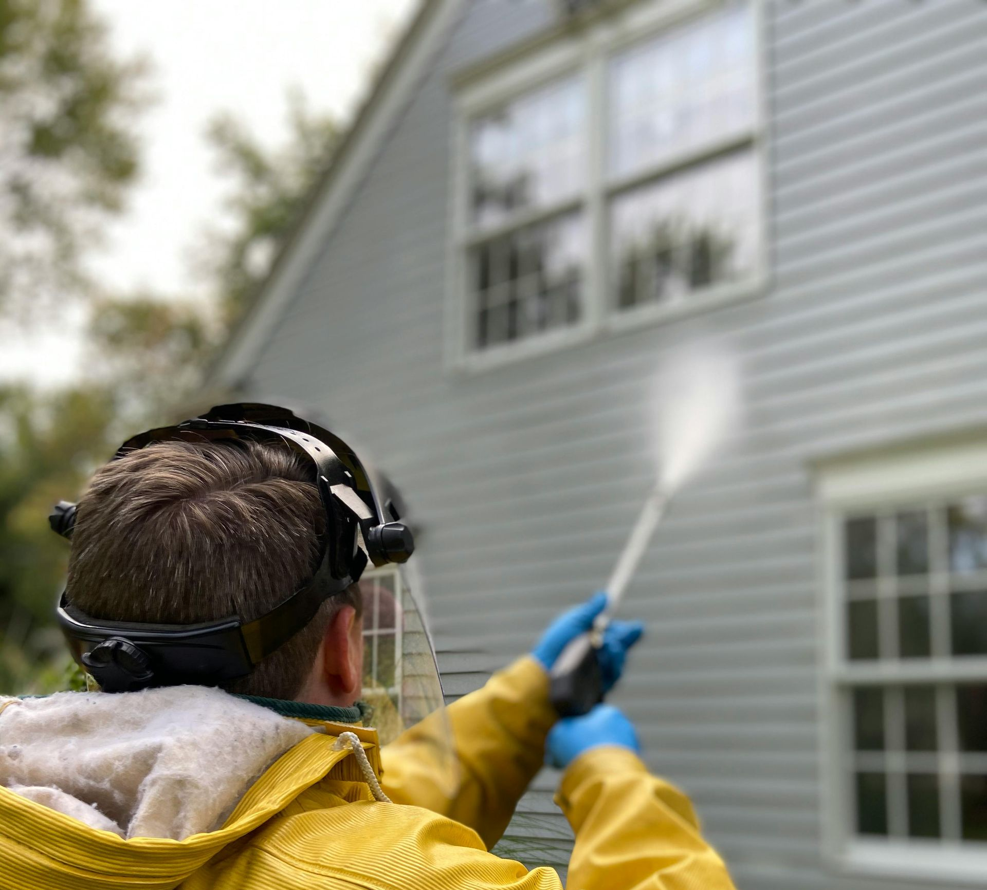 A person is putting something on a wooden shelf.