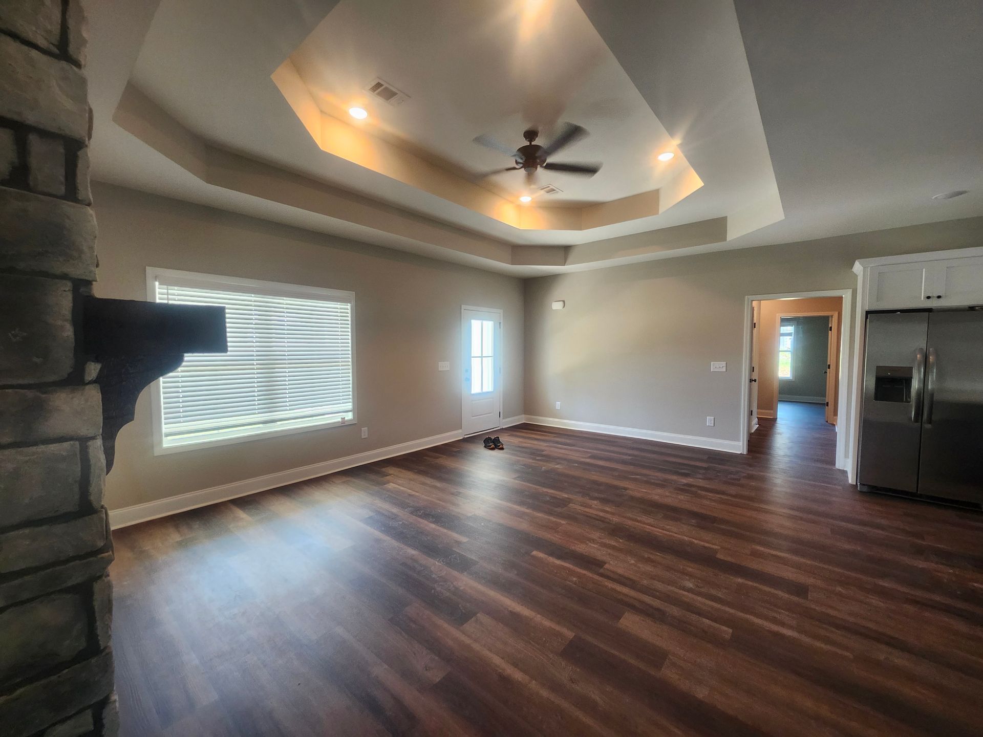 A person is putting something on a wooden shelf.