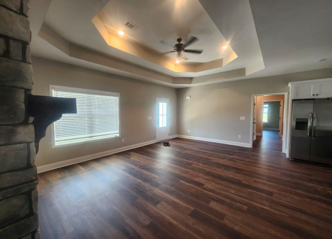 A person is putting something on a wooden shelf.