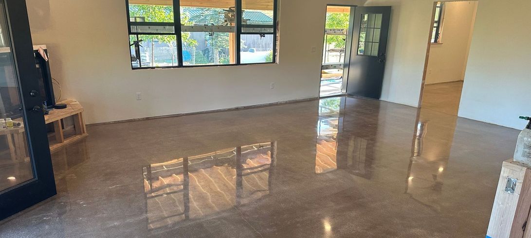 A large room with a shiny concrete floor and a lot of windows.
