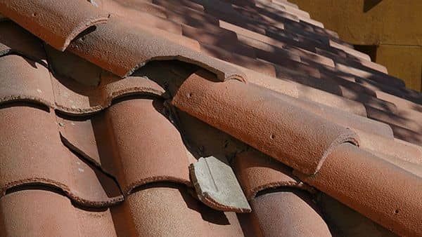 Broken Red terracotta roof tiles, close-up view in daylight.