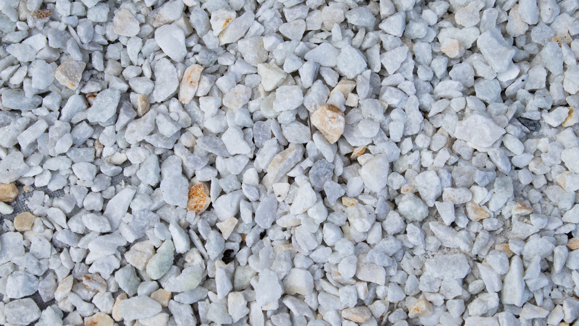 A pile of white gravel is sitting on the ground.