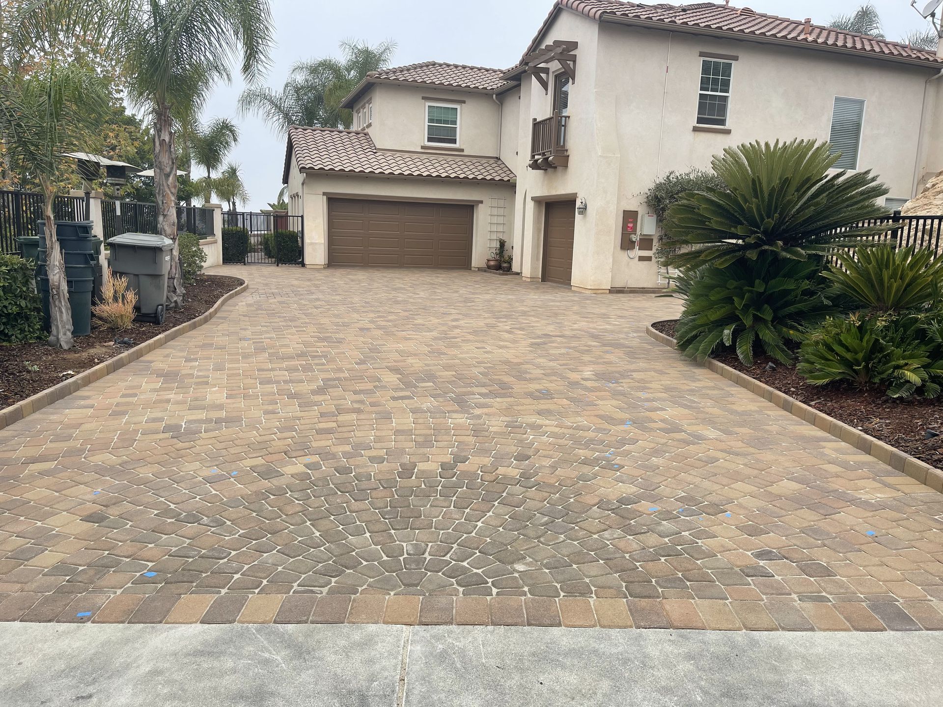 A large house with a brick driveway leading to it