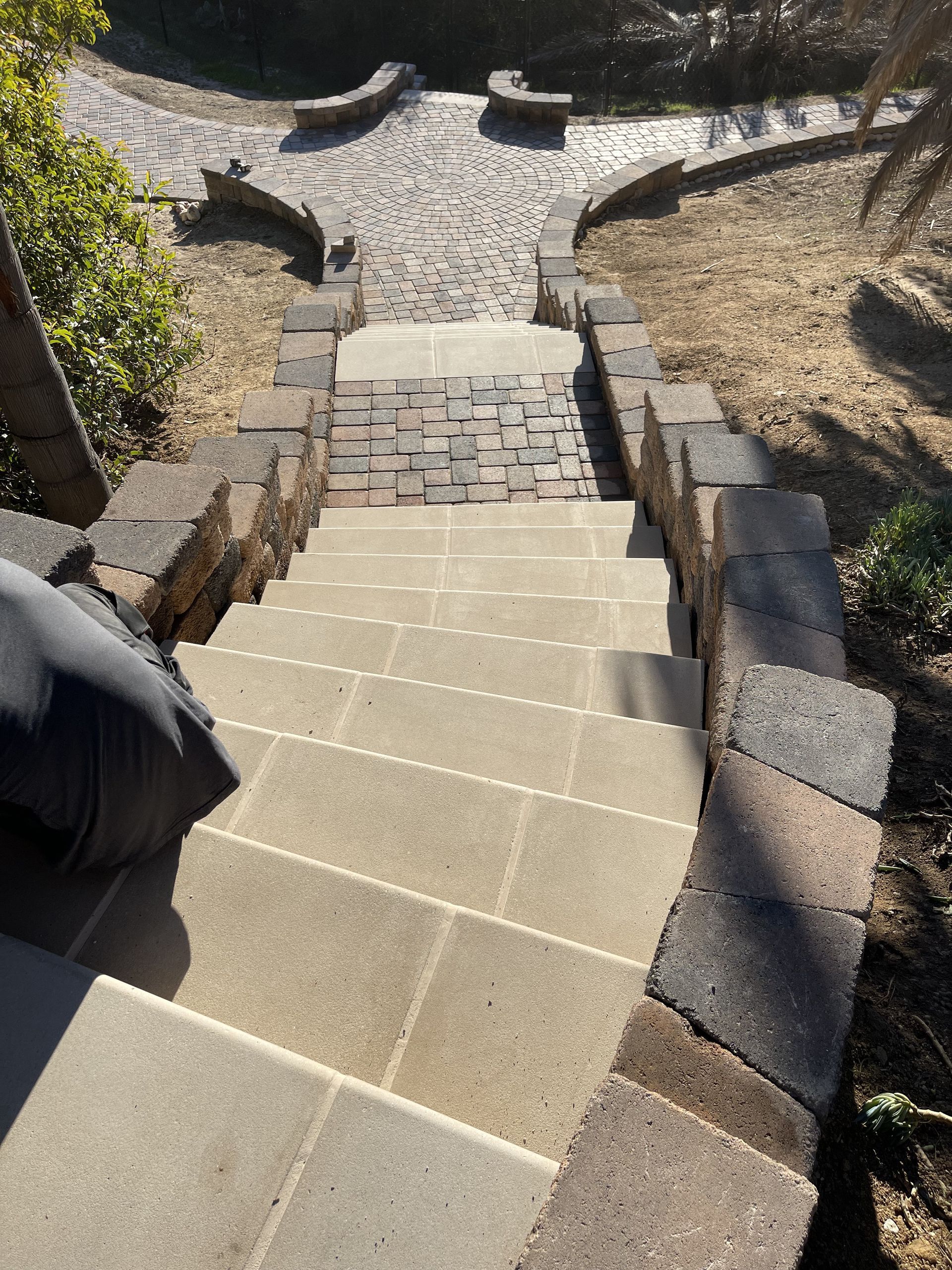 A set of stairs leading up to a brick walkway