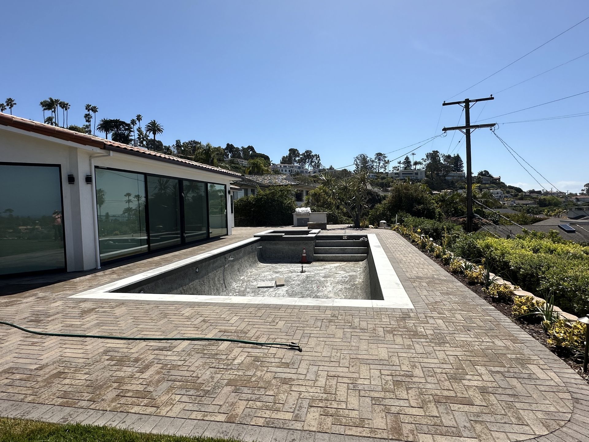 A large swimming pool in the backyard of a house