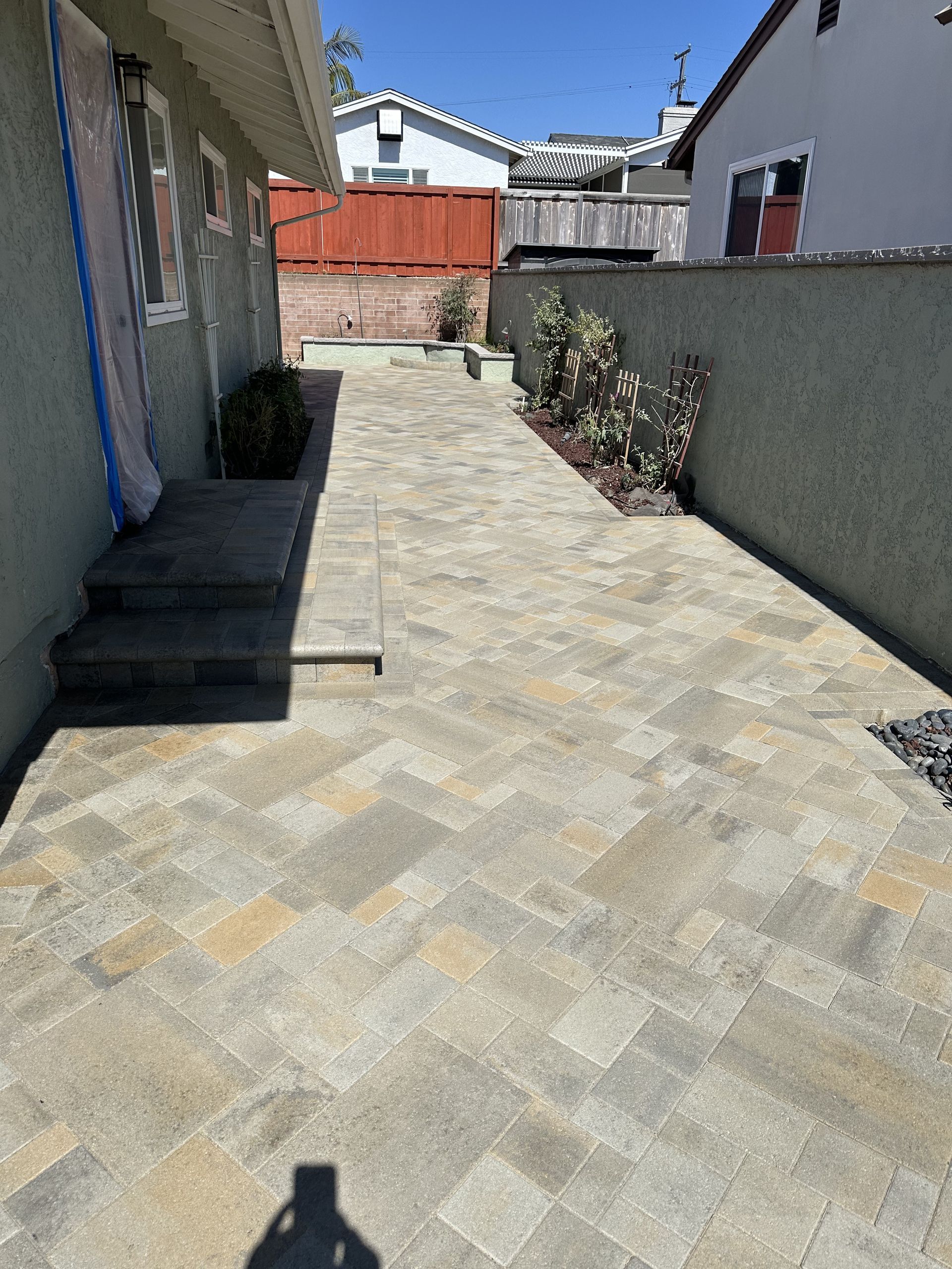 A brick walkway leading to the front door of a house
