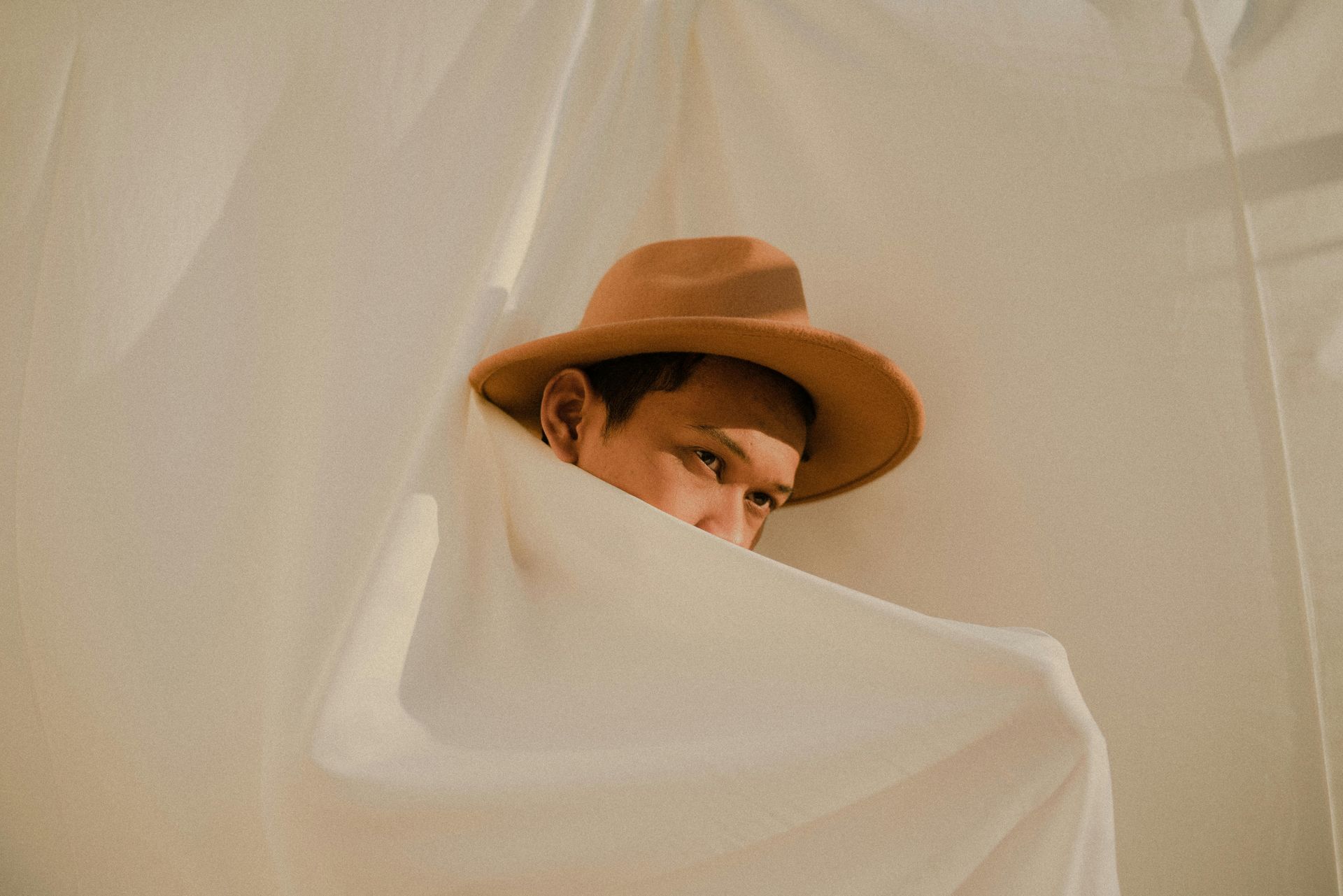 man hiding in white cloth