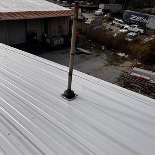 A metal roof with a antenna on top of it.