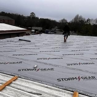 A man is standing on the roof of a building.