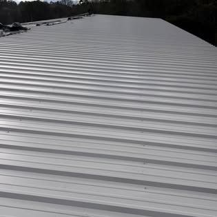 A close up of a white metal roof on a building.