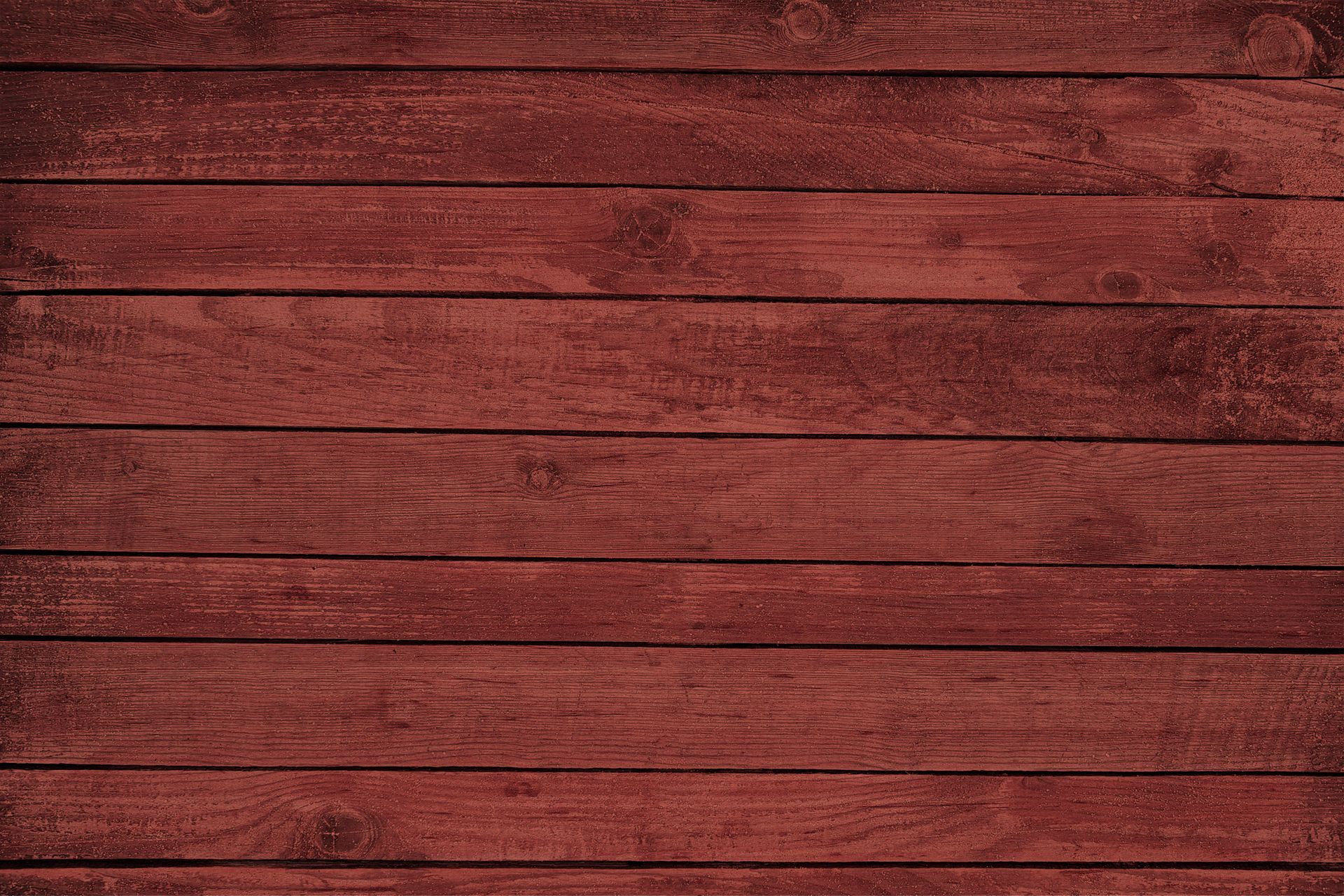 A close up of a red wooden plank wall.