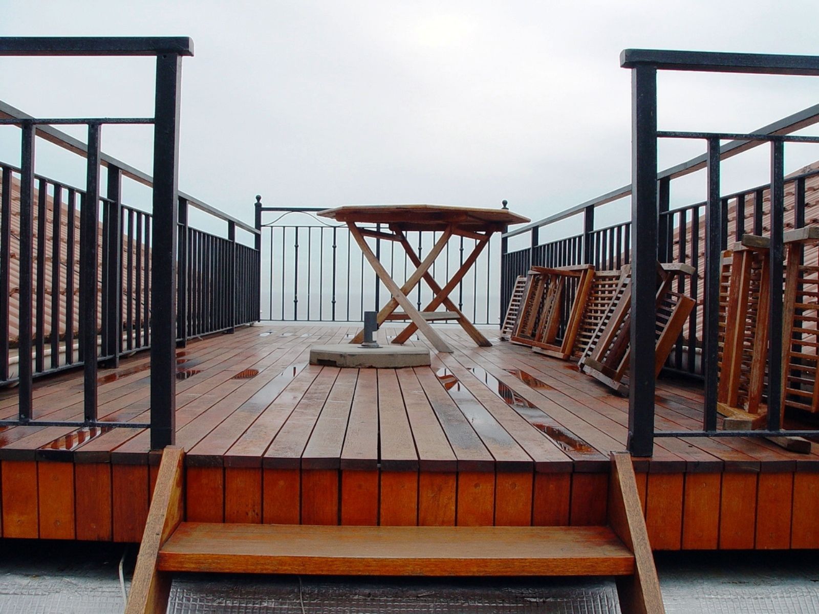 A wooden deck with a table and chairs on it
