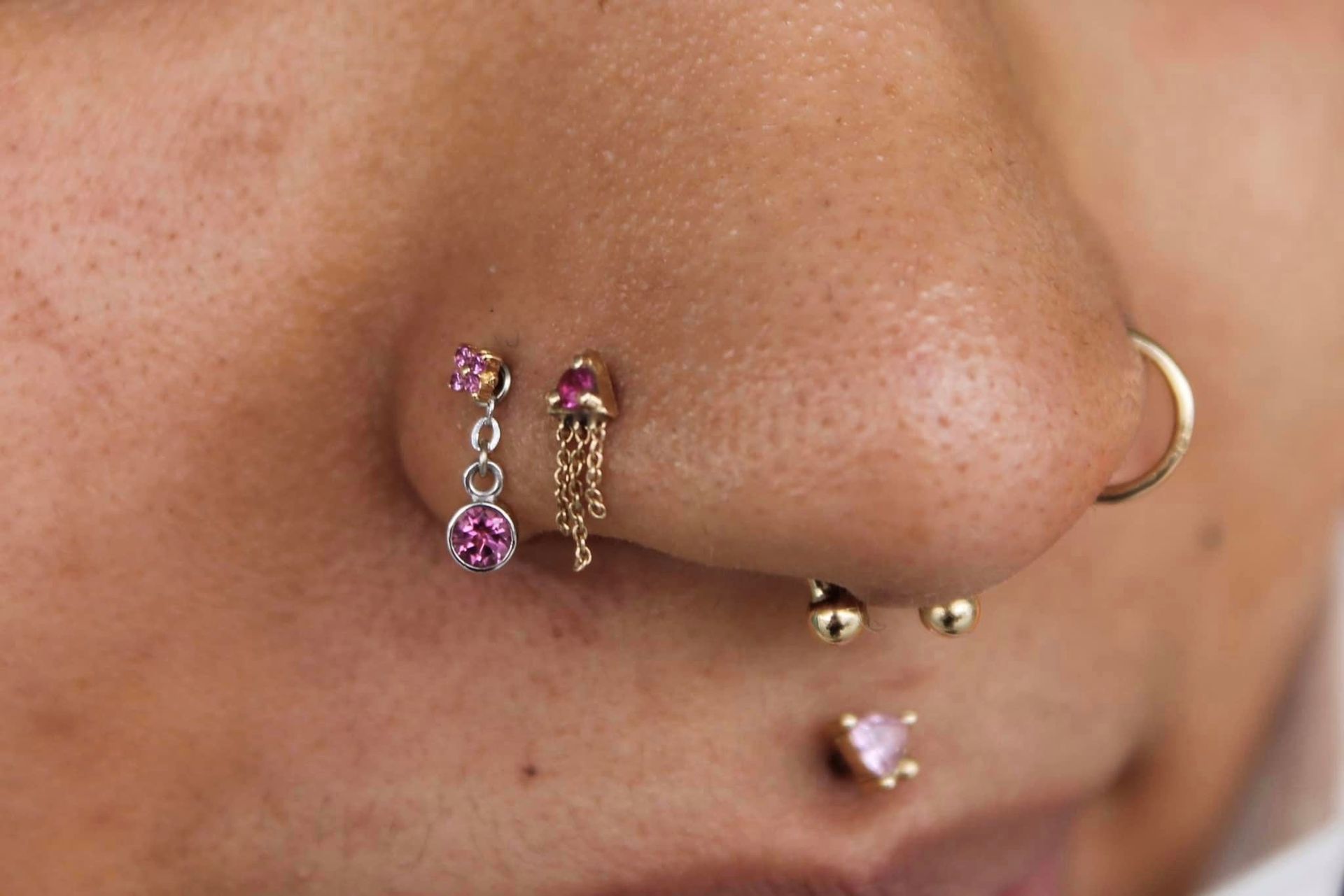 A close up of a woman 's ear with multiple piercings