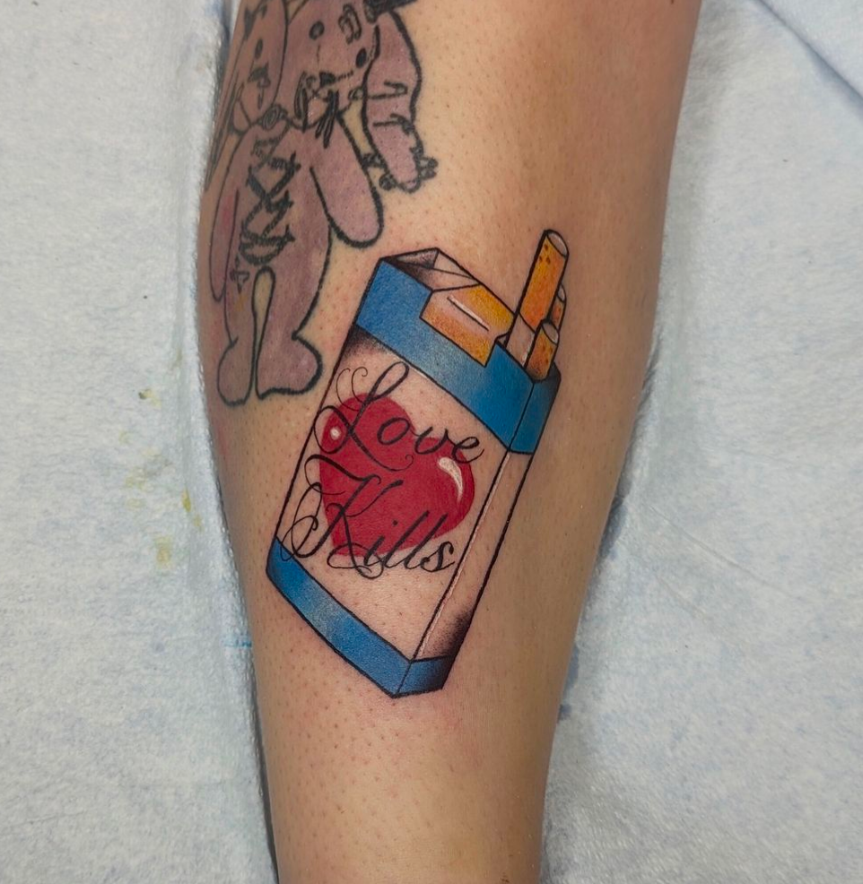 A tattoo of a pack of cigarettes that says love kills