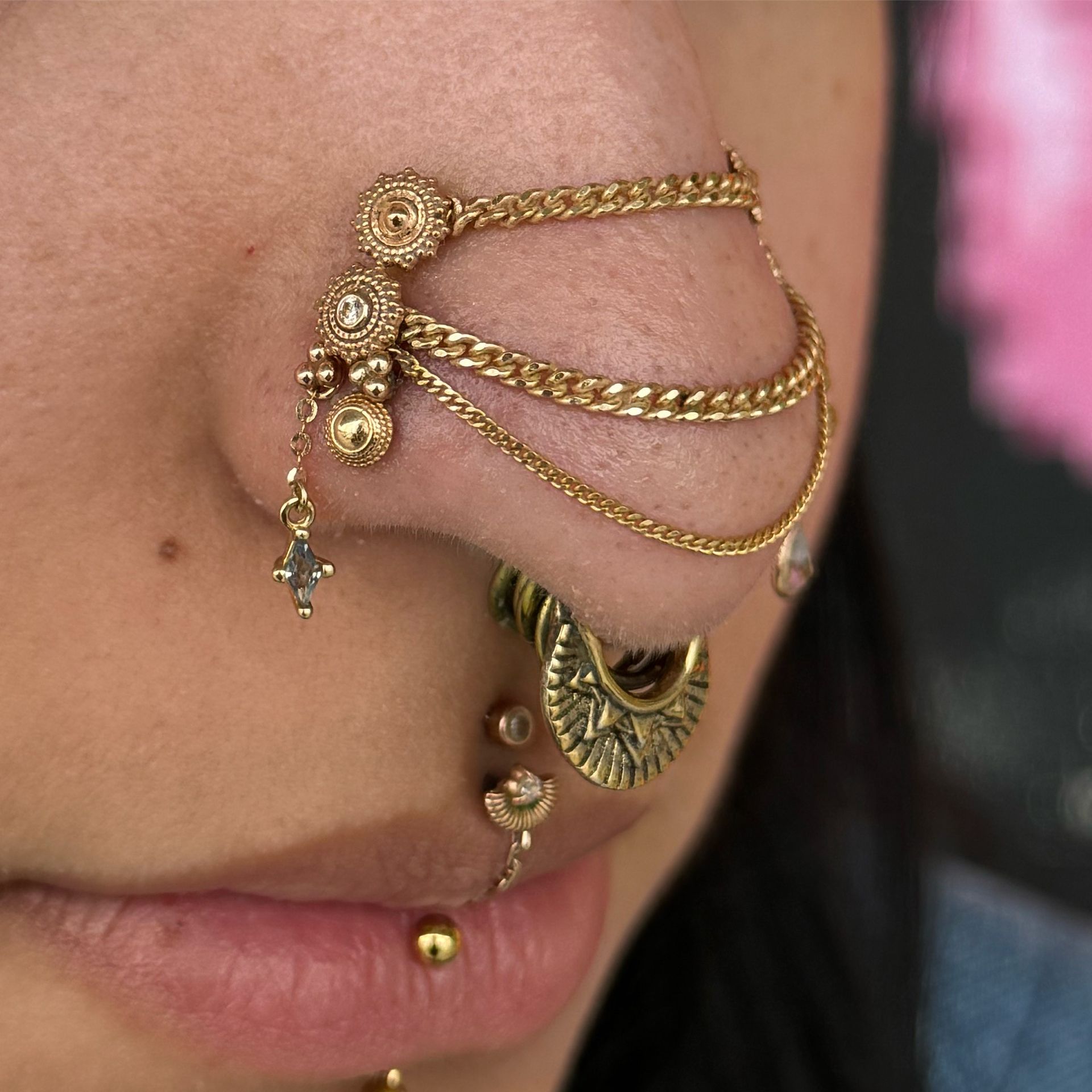 A close up of a woman 's face with a piercing in her eyebrow. - Manhattan, NY - Studio 28 Tattoo