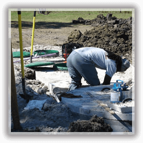 Septic Services in Alvin — A Man Repairing a Septic Tube in Alvin, TX