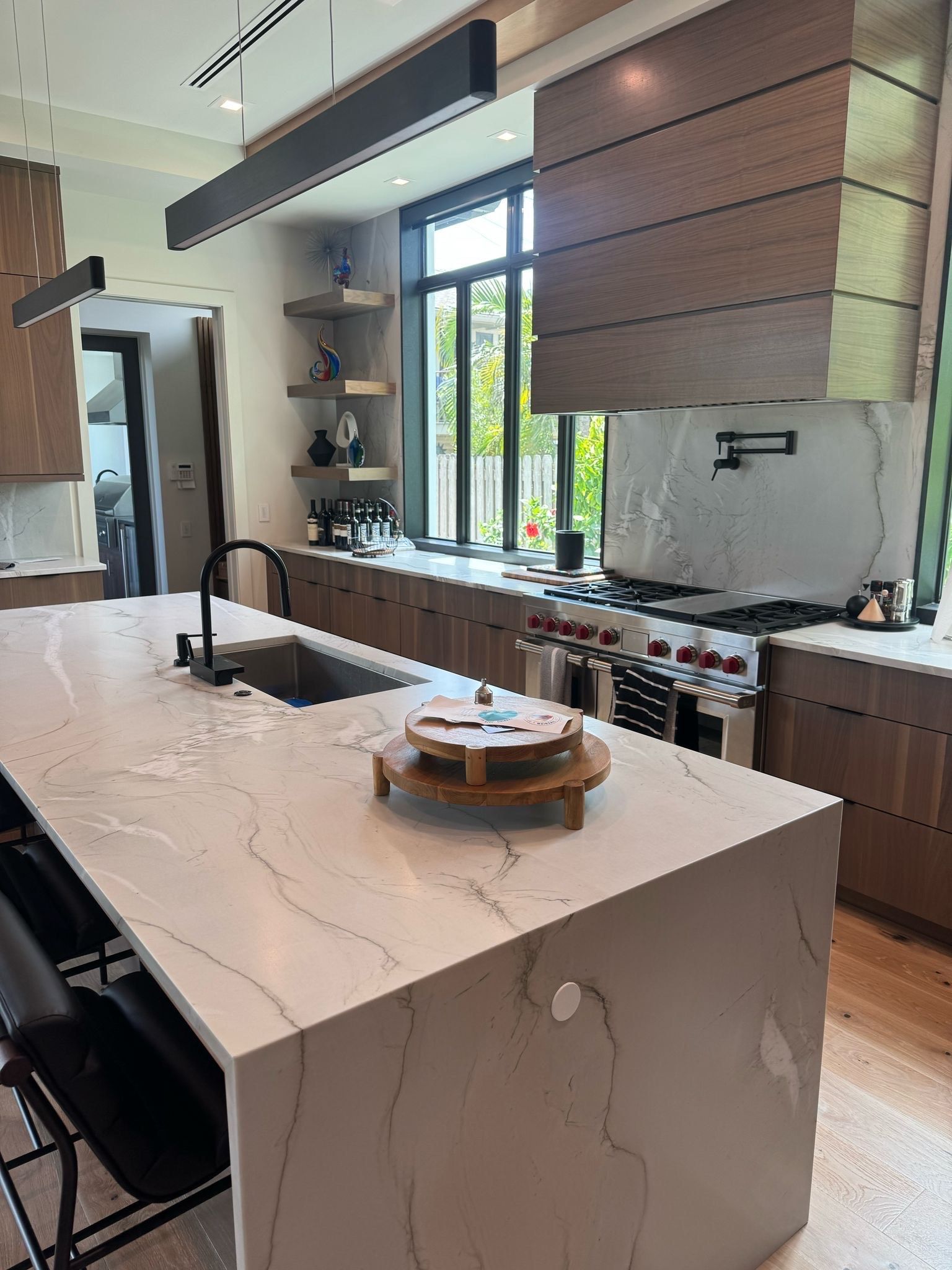 A kitchen with wooden cabinets and a stove top oven.