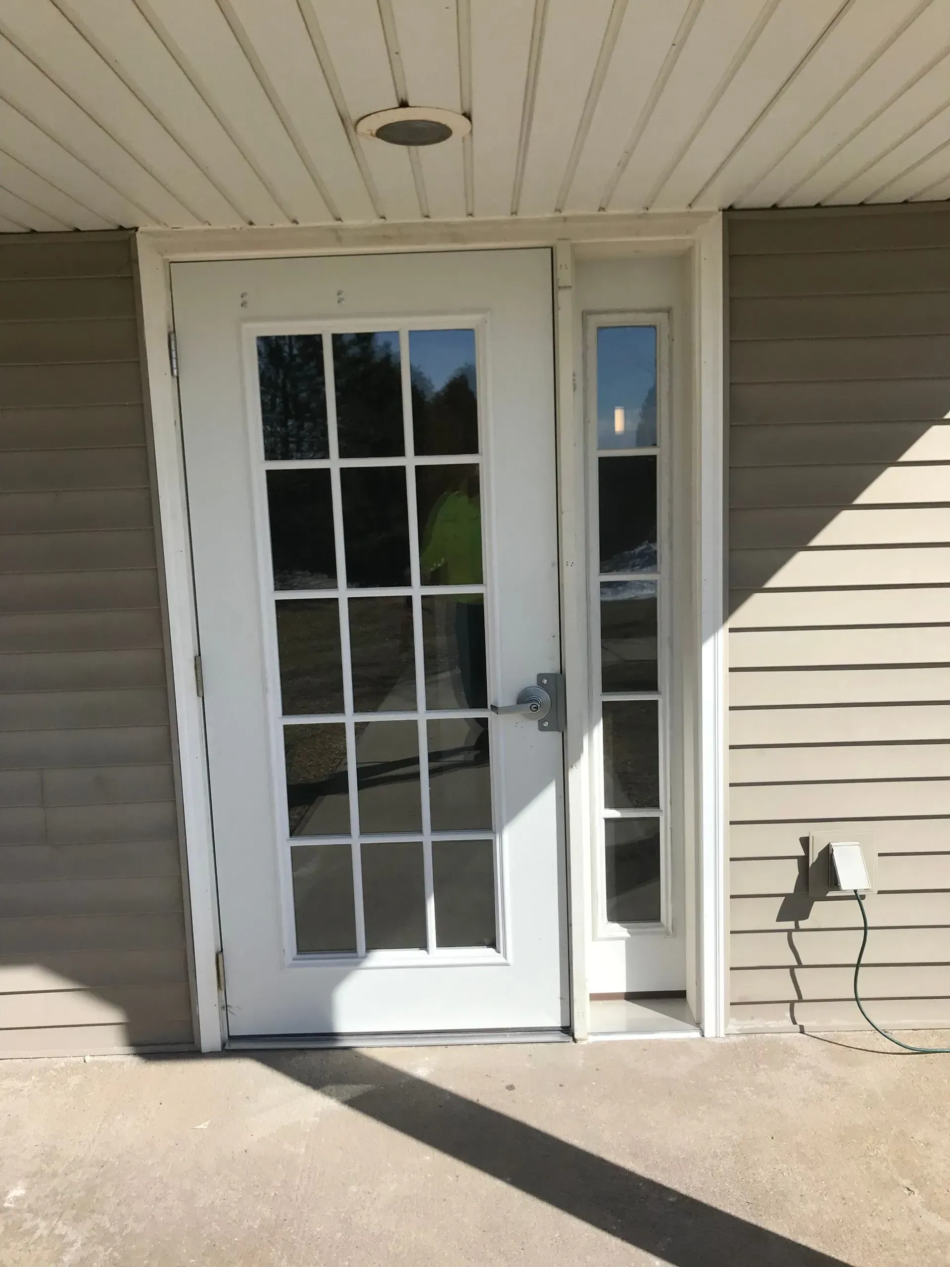 A white door with a reflection of a person in it
